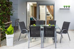 a dining room with a glass table and chairs at Placebo Apartment in Kritharia