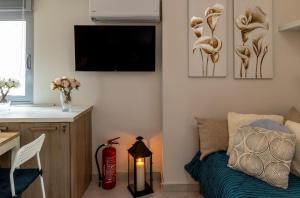 a living room with a bed and a tv at Placebo Apartment in Kritharia