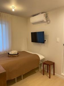 a room with a bed and a flat screen tv at stay early mansion 가산, 홍대, 고척돔 in Seoul