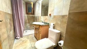 a bathroom with a toilet and a sink and a shower at Castle Harbour 2 Bed Duplex in El Guincho +7 photos