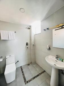 Un baño blanco con inodoro y lavabo. en Little Buddha Inn, en Katmandú 58 fotos más