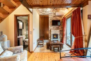 a living room with a fireplace and a stone wall at Sokaki in Megalo Chorio