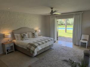a bedroom with a bed with two pillows on it at Hartland Country House Luxury Ensuite Rooms in Oudtshoorn