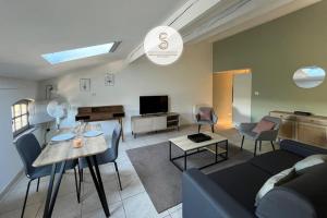 a living room with a couch and a table at Emily in Provence Arles Centre in Arles
