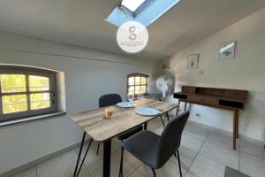 a room with a table and chairs and a piano at Emily in Provence Arles Centre in Arles