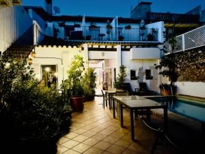 a patio with tables and chairs next to a pool at Casa Sibarita in Rafelguaraf