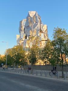 a tall building in the middle of a street at Emily in Provence Arles Centre in Arles +4 photos
