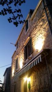 a stone building with lights on the side of it at Buena Vis-ta Apartments with the Sea View in Vis