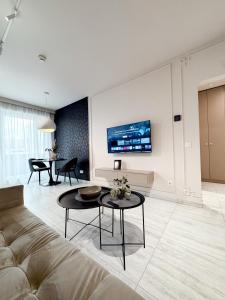 a living room with a couch and a table at Sky Escape-Private Parking, Kingsize Bed in Cluj-Napoca