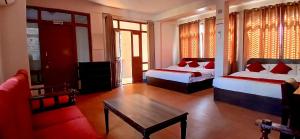 a hotel room with two beds and a couch at Hotel Silver Jubilee in Kathmandu +42 photos
