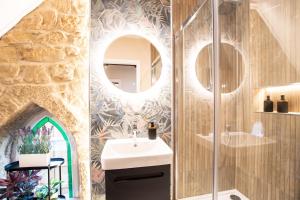 a bathroom with a sink and a shower with a mirror at Northern Hideaways The Old Chapel, Otterburn in Otterburn