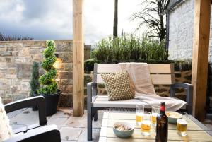a patio with a chair and a table at Northern Hideaways The Old Chapel, Otterburn in Otterburn