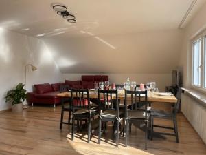 a dining room with a table and chairs and a couch at Haus87a Apartment 1 in Oberkirch