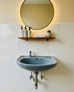 ein Waschbecken im Badezimmer mit einem Spiegel an der Wand in der Unterkunft Ahluwalias Farmstay in Mandlā