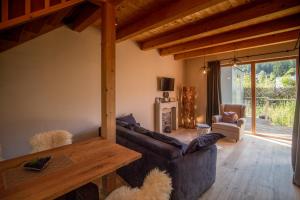 a living room with a couch and a table at Bio Chalets Alpegg in Waidring