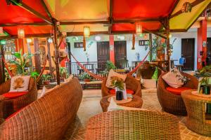 a restaurant with wicker chairs and tables in a room at Bulskamp Inn in El Nido