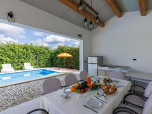 a dining room with a table and a swimming pool at Casa Jurican in Višnjan