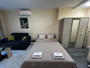 a small room with a bed and a couch at One room apartment 112 Аll-season в Св св Константин и Елена in Varna City +17 photos