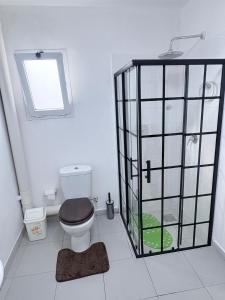 a bathroom with a toilet and a window at GuestHouse16 in Kuito +21 photos