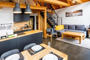 a kitchen and living room with a couch and a table at Chata Jestřáb in Hlinsko +17 photos