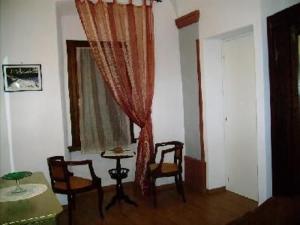 a living room with a table and chairs and a window at Wohnung Oleandro In Miasino in Miasino