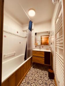 ein Badezimmer mit Badewanne und Waschbecken in der Unterkunft Appartement T2, 20m des Pistes, En Relooking in Les Angles