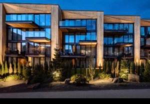 a large building with a lot of windows at Giewont View Sośnica Residence & Spa in Zakopane