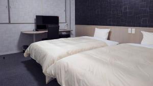 Postel nebo postele na pokoji v ubytování ホテルテラス小名浜