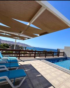 a patio with chairs and a swimming pool at Saraya Abdeen Hotel in Aqaba