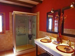 a bathroom with two sinks and a shower at Casa Número 1 in Válor +32 photos