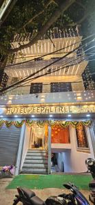 a building with a sign on the side of it at Hotel Peepal Tree Prayagraj in Prayagraj