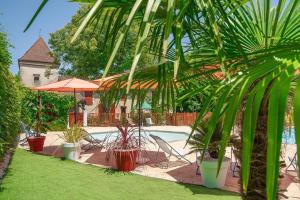 a pool with chairs and plants in a yard at Camping 3 étoiles - Parc aquatique - ccba0ec in Urt
