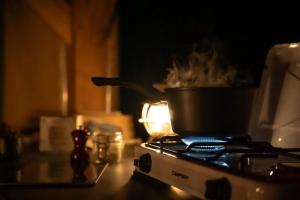 a pot on top of a stove in a kitchen at Camping 3 étoiles - Parc aquatique - ccba0ec in Urt