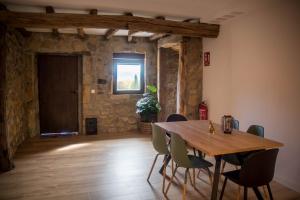 a dining room with a wooden table and chairs at Arrutela in Hondarribia