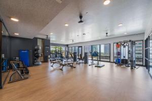 a gym with treadmills and exercise equipment in a building at Stylish Condo Mins to Shoreline in Long Beach