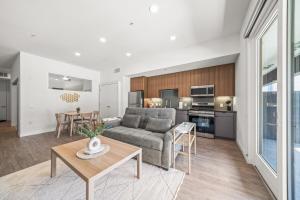 a living room with a couch and a table at Stylish Condo Mins to Shoreline in Long Beach