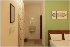 a bedroom with a bed and a toilet in a room at Lagoon Stays, Gokarna in Gokarna