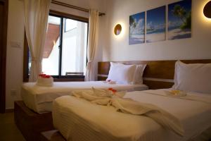 Postel nebo postele na pokoji v ubytování Oshi Boutique