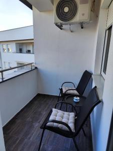 a balcony with a chair and a fan at Apartman Maela in Županja