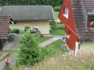 einem Luftblick auf ein Haus mit einer roten Scheune in der Unterkunft Ferienhaus für 3 Personen  1 Kind ca 85 m in Eisenbach, Schwarzwald Naturpark Südschwarzwald in Oberbränd
