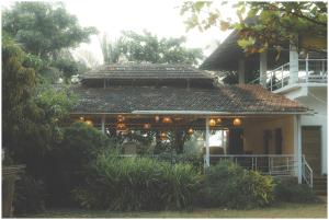 a house with a porch with lights on it at Lagoon Stays, Gokarna in Gokarna