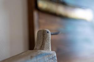 a close up of a wooden figurine of a bird at Dorfring 36 Seeadler in Stein +25 photos