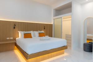a bedroom with a large white bed with orange pillows at Garto Beach Resort Samui in Ban Bang Po