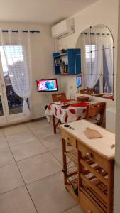 a living room with a table and a tv at Sanary Bandol plein SUD in Sanary-sur-Mer +4 photos