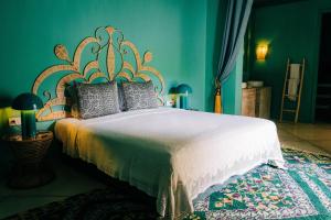 a bedroom with a large white bed with blue walls at Riad Nashira & Spa in Marrakesh +93 photos