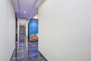 a corridor in a building with a blue wall at Hotel O Golden in Vadodara