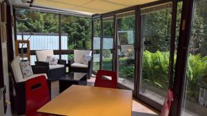 a room with a table and chairs and windows at Ferienhaus In Maxen Mit Privatem Pool in Müglitztal +18 photos