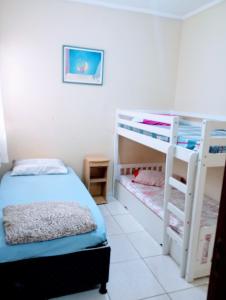a bedroom with two bunk beds and a bed at VERTT Engenharia in Campo Grande