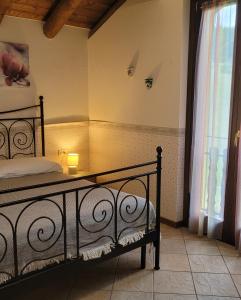 a bedroom with a bed with a lamp on it at Cinque Abeti Agrialloggio Mountain Lake Iseo Hospitality in Bossico