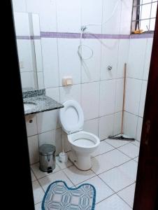 a bathroom with a toilet and a sink at VERTT Engenharia in Campo Grande